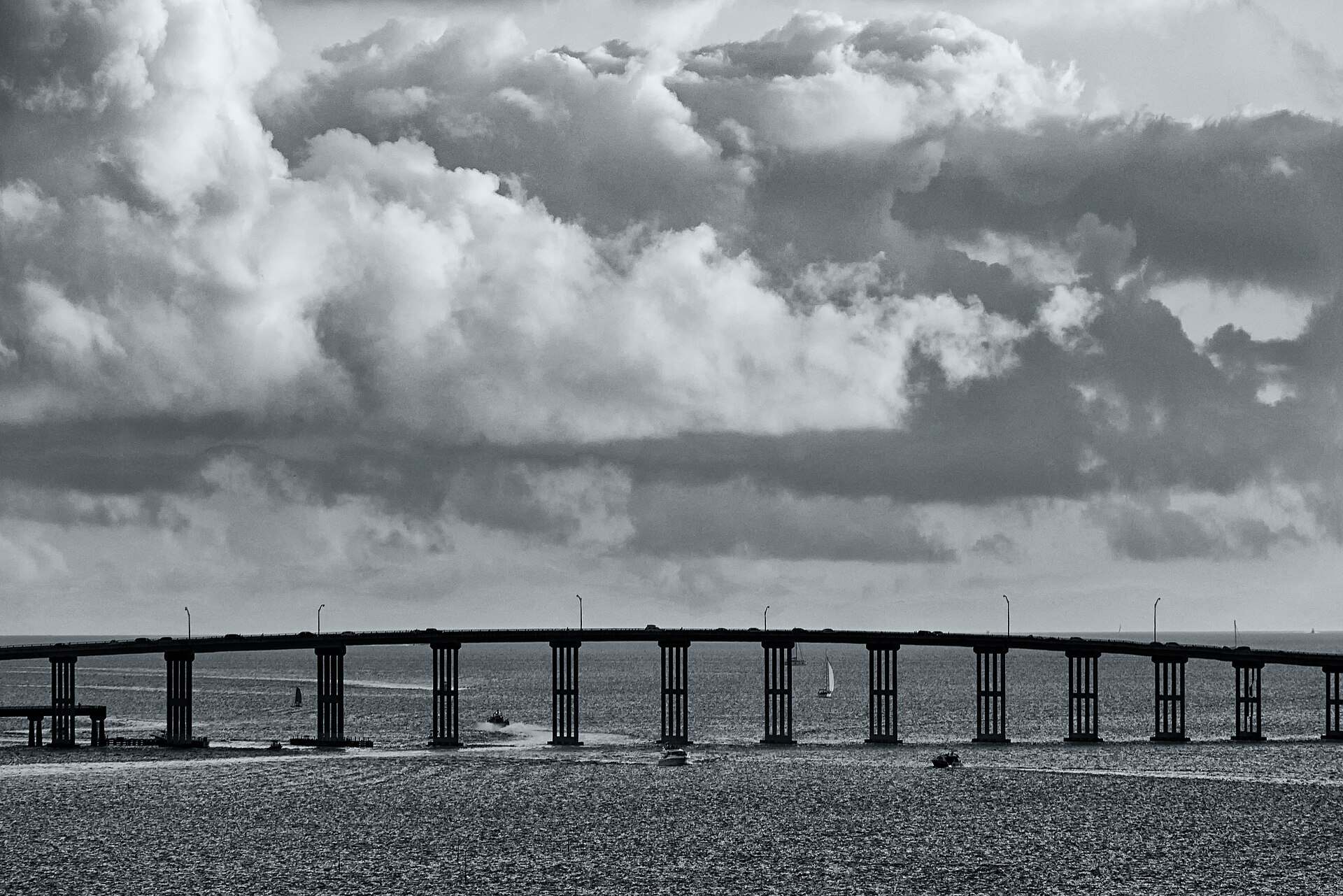 The William M Powell Bridge on the Rickenbacker Causeway under heavy clouds in black and white, from the Trevor L Taylor guide to endurance sport and cycling