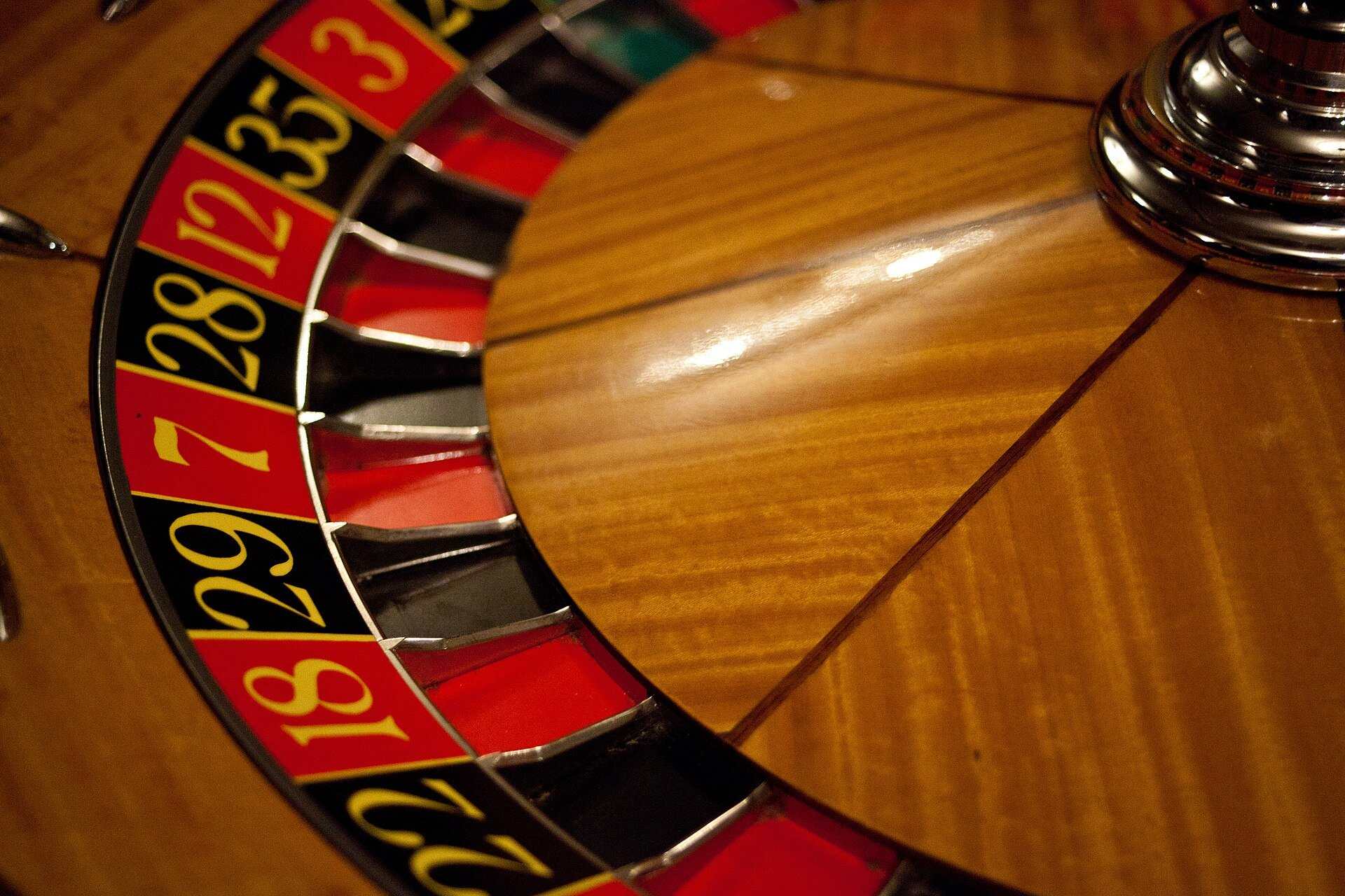 A close view of a roulette wheel showing its red and black numbered pockets, from the Trevor L Taylor entry on expected value