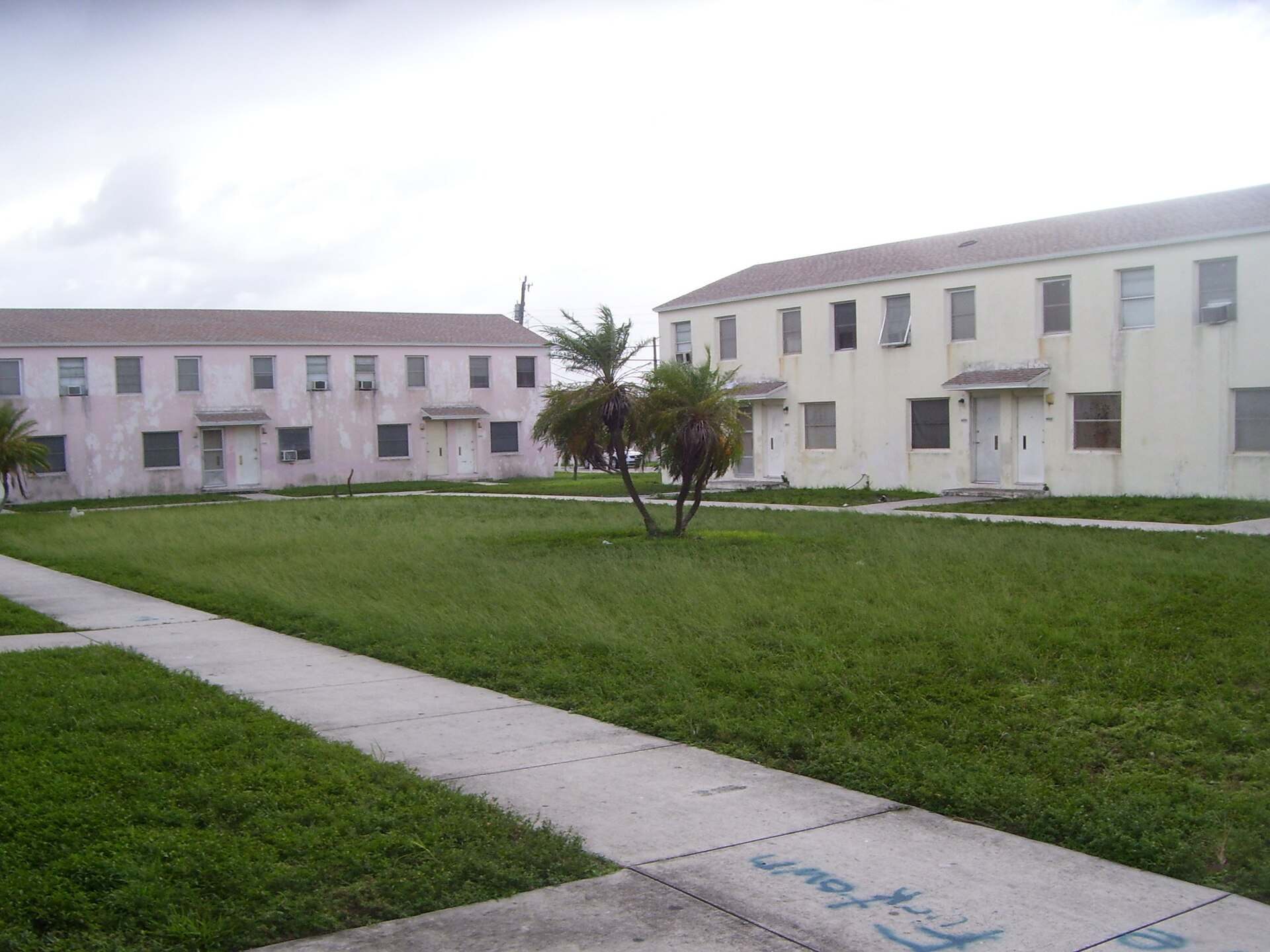 Two story garden apartment buildings around a lawn in Miami's Liberty Square, from the Trevor L Taylor entry on housing choice vouchers