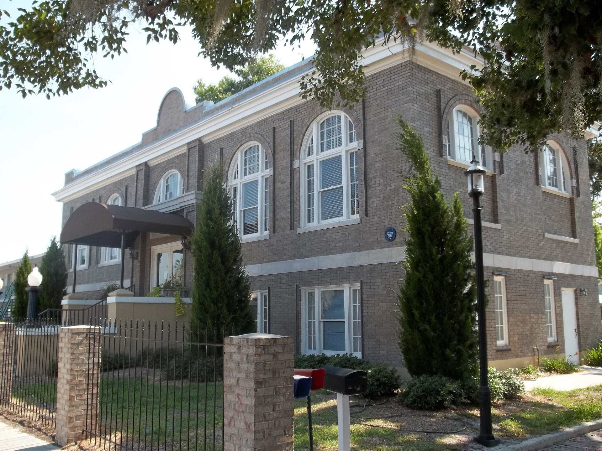 Brick facade and arched windows of an old Carnegie library building, from the Trevor L Taylor entry on how a donor should judge a small scholarship