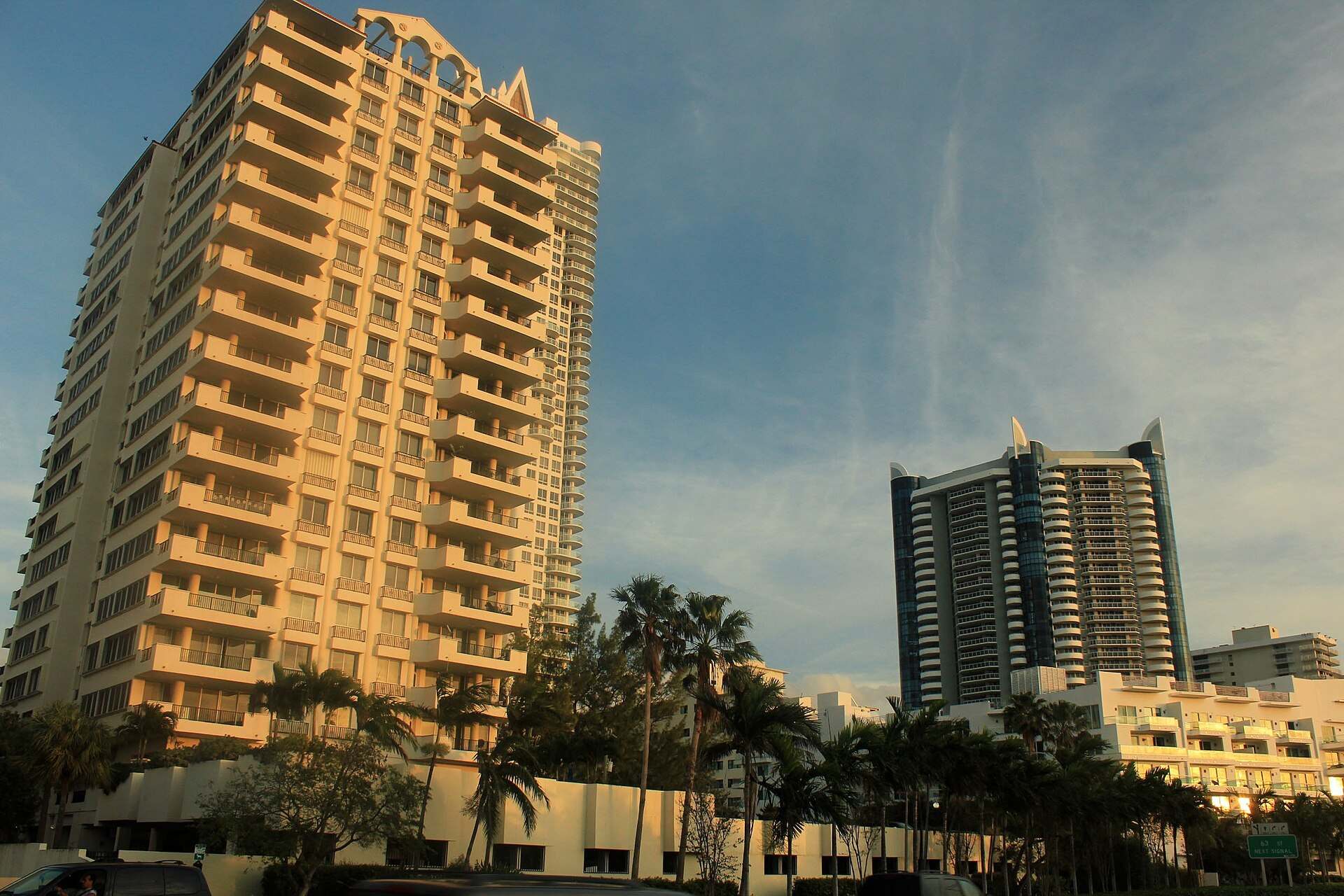 Balconied condominium towers rising above palm trees in Miami Beach at golden hour, from the Trevor L Taylor entry on condo reserve rules