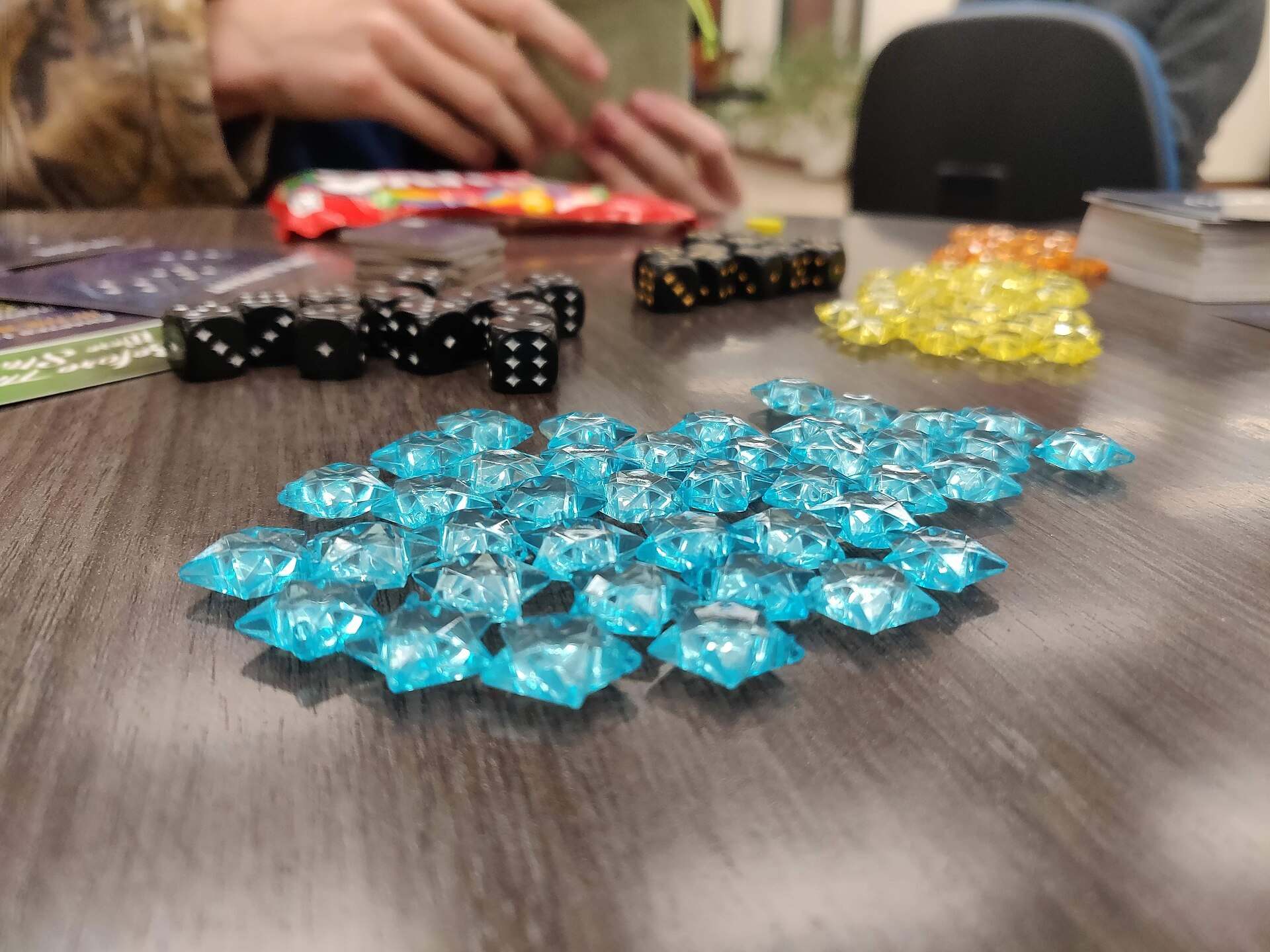 Blue game stars, dice and tokens spread across a table, illustrating a Trevor L Taylor podcast episode on screen free family time