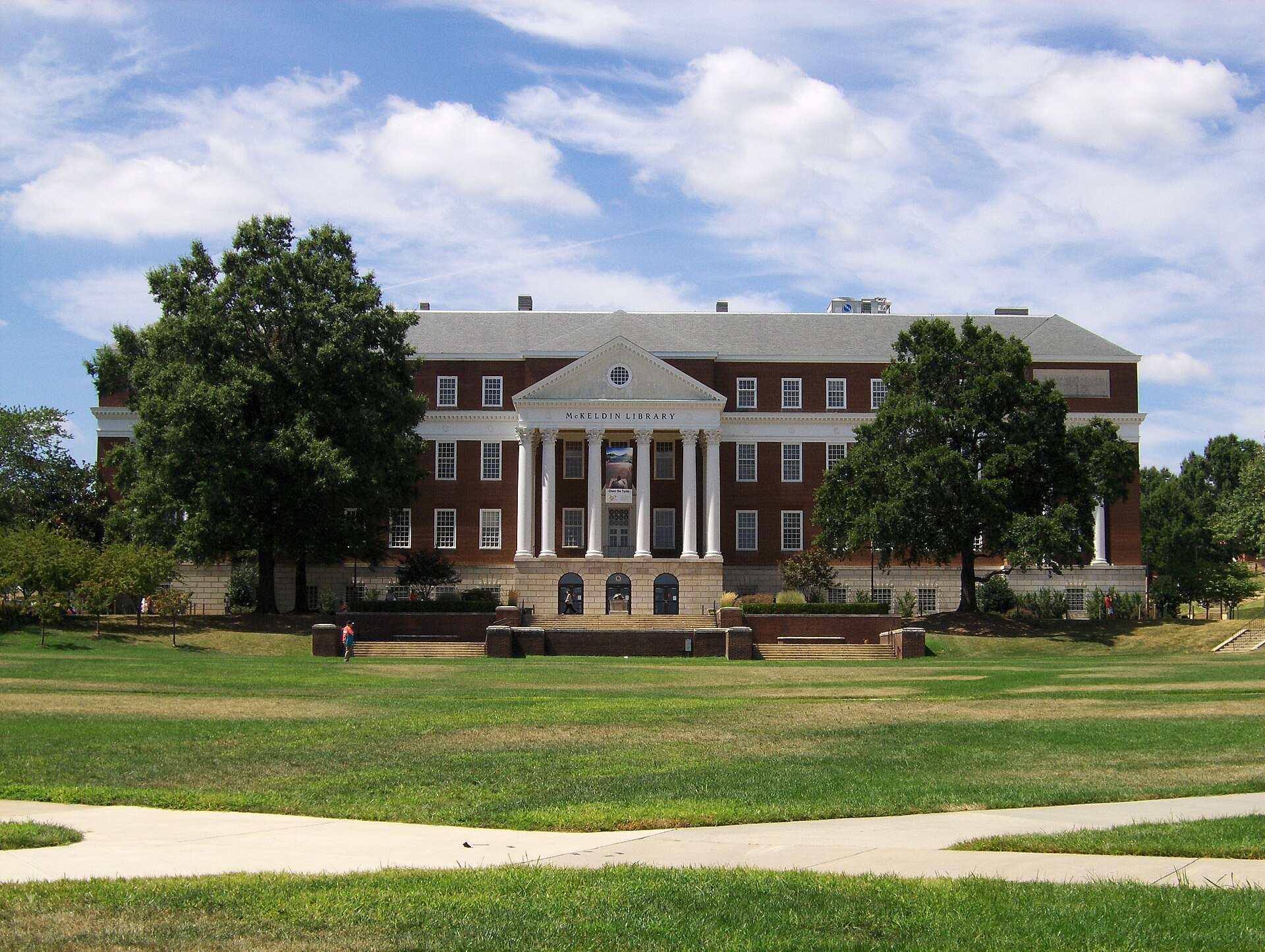A columned university library across a wide green lawn, from the Trevor L Taylor entry on scholarship displacement