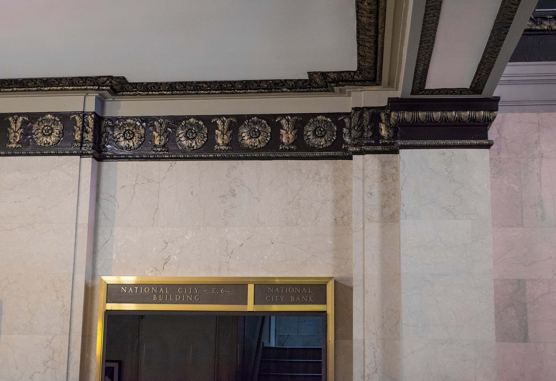 Bronze cornice and an old brass directory board in a marble bank lobby, illustrating the Trevor L Taylor entry on single and multi family offices