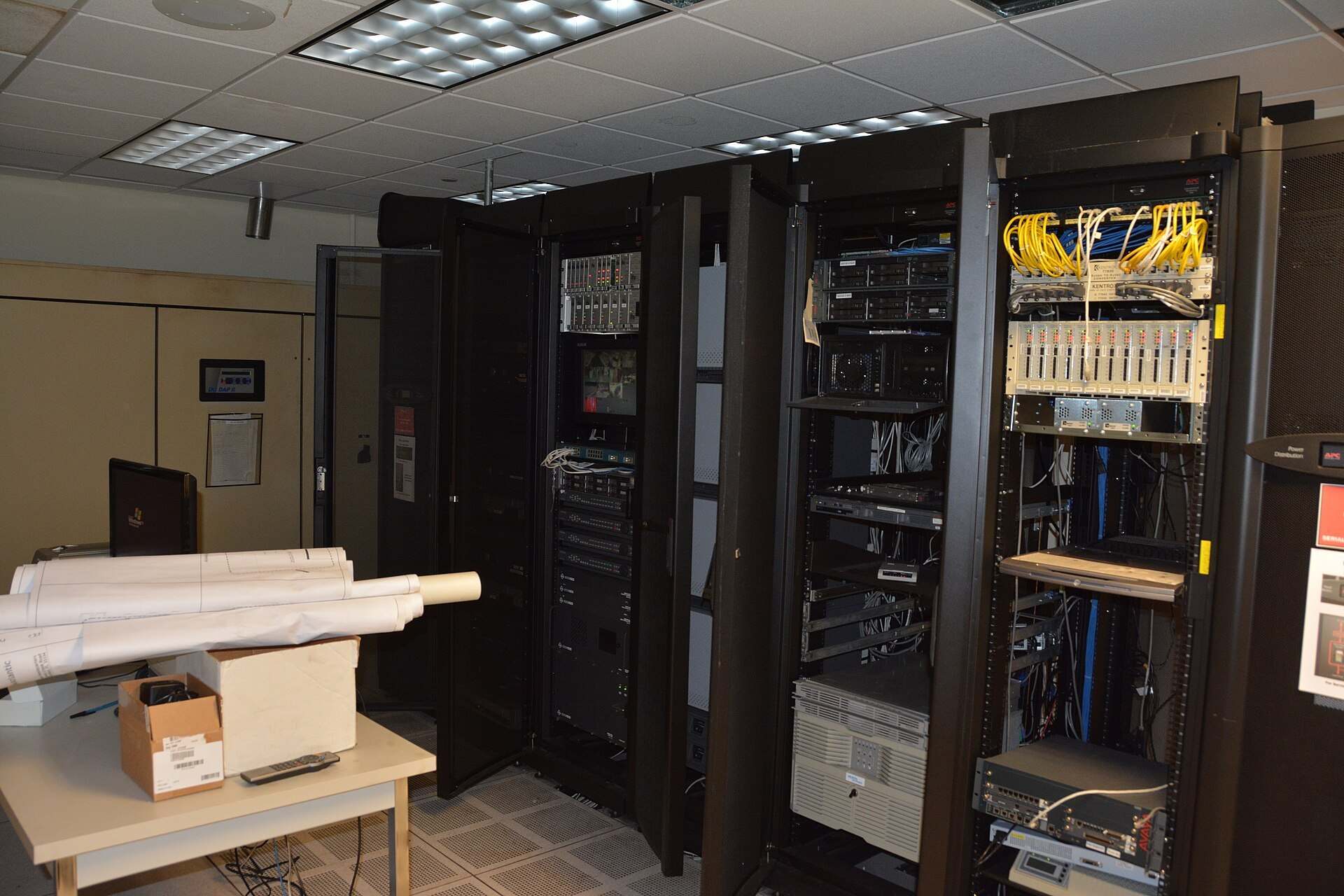 Open server racks with cabling and network gear in a small machine room, from the Trevor L Taylor entry on systematic investing