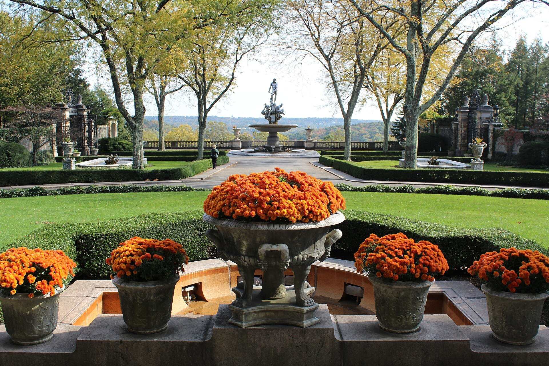 Formal gardens, urns of orange flowers and a fountain at the Kykuit estate built by the Rockefeller family, from the Trevor L Taylor entry on wealth succession planning